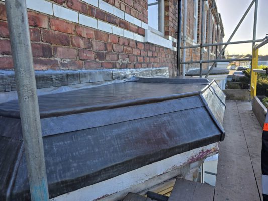 Completed heritage lead bay window in Saltburn-by-the-Sea with Code 5 cast lead, welted seams, copper cleats, and drip detail by Samuel Moore Roofing